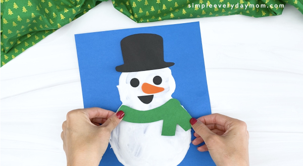 hand gluing scarf to puffy paint snowman
