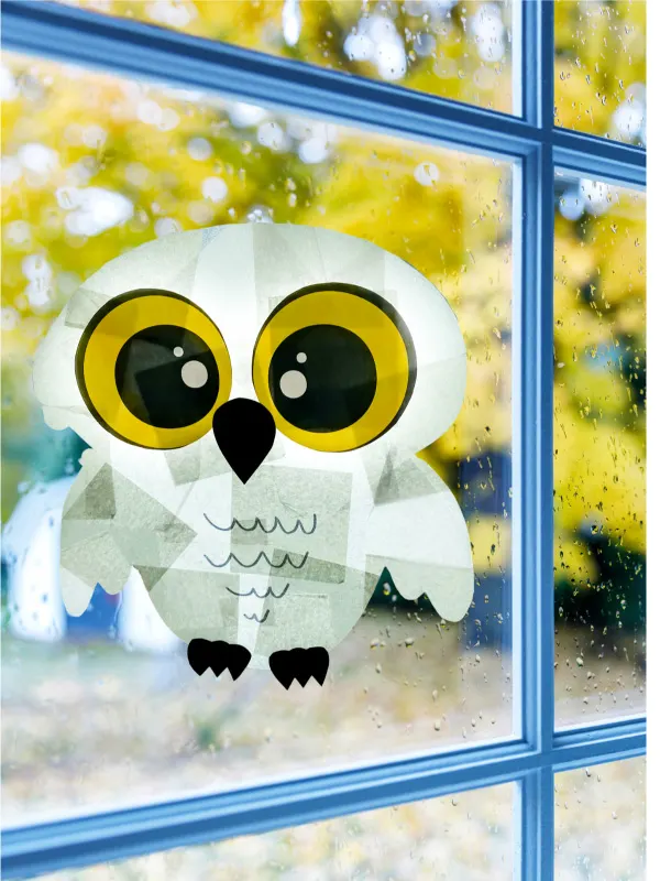 snowy owl sun catcher on window