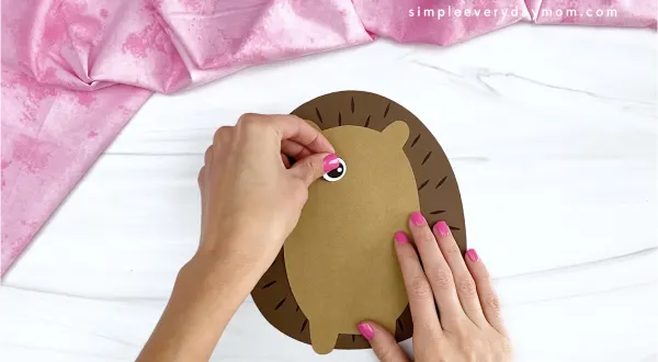 hand gluing eye to hedgehog valentine craft