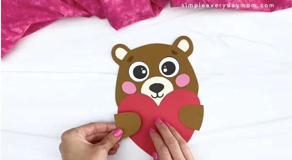 hand gluing arm to bear Valentine craft