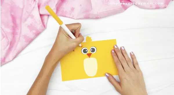 hand drawing eyebrows onto chick toilet roll craft