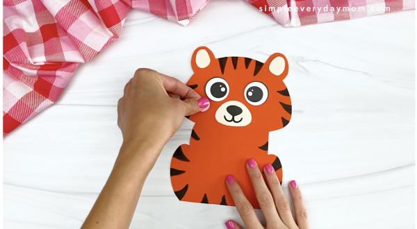 hand gluing cheek to tiger Valentine craft
