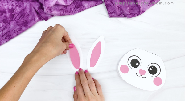 hand gluing inner ears to outer ears of bunny card craft