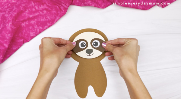 hand gluing face to sloth Valentine craft