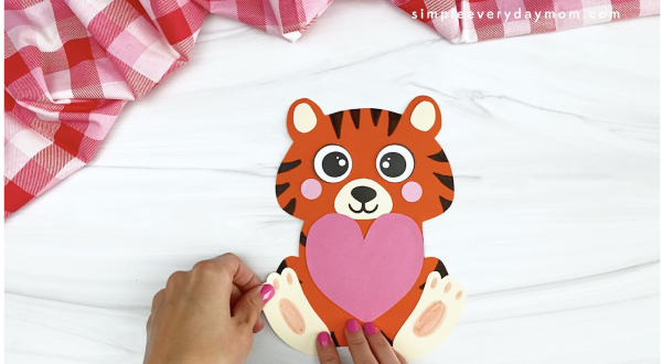 hand gluing foot to tiger Valentine craft