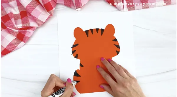 hand drawing stripes onto tiger Valentine craft