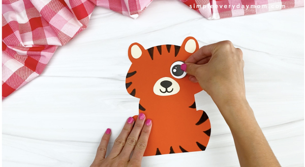hand gluing eye to tiger Valentine craft