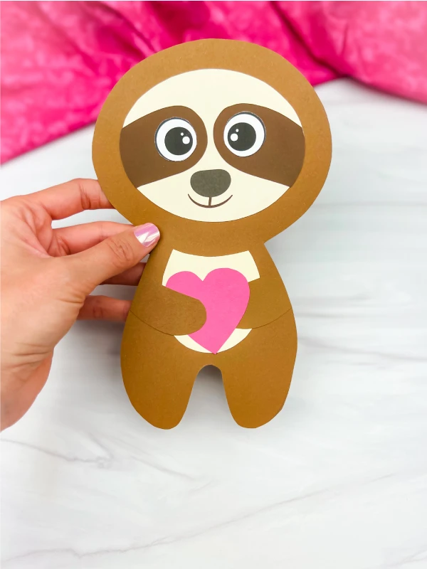hand holding sloth Valentine craft