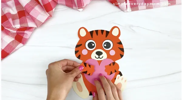 hand gluing hand to tiger Valentine craft