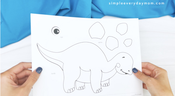 hand holding printable dinosaur craft template