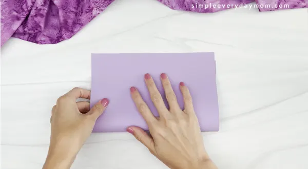 hand folding bunny handprint card base in half