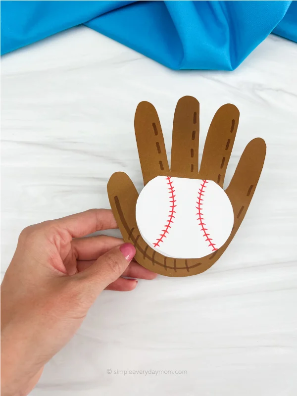 hand holding handprint baseball card craft under title FATHER'S DAY CRAFTS FOR SENIORS
