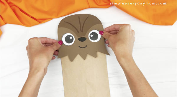 hand gluing head to Chewbacca paper bag craft