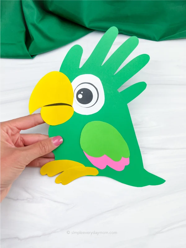 hand holding handprint parrot craft