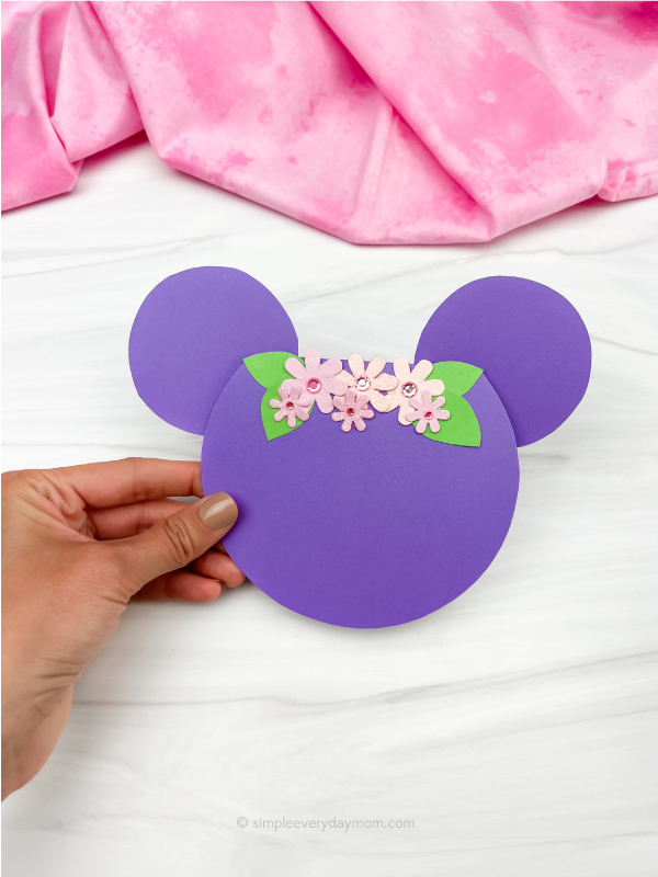 hand holding finished example of Mickey Mouse card craft