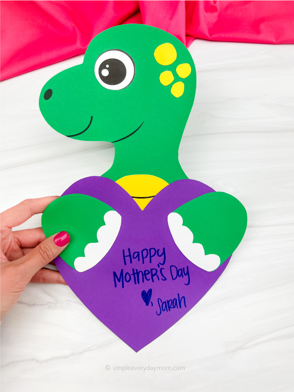 hand holding dinosaur mother's day craft
