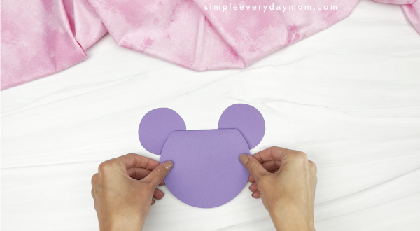 hand gluing ears onto Mickey card craft