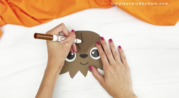hand drawing hair onto Chewbacca paper bag craft