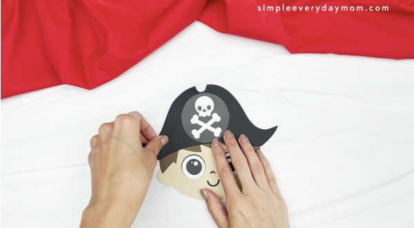 hand gluing hat onto pirate card craft