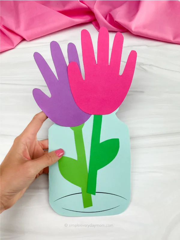 hand holding handprint flower card craft