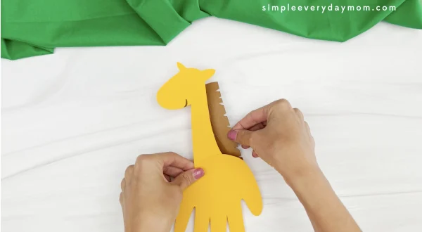hand gluing neck hair to handprint giraffe craft
