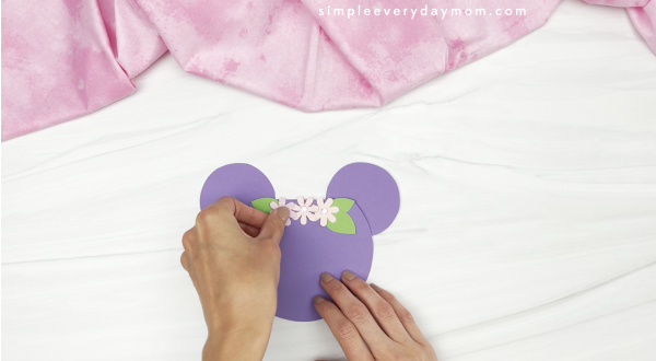 hand gluing flowers onto Mickey card craft
