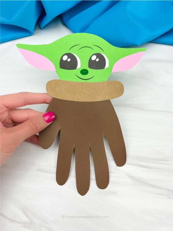 hand holding Baby Yoda handprint craft