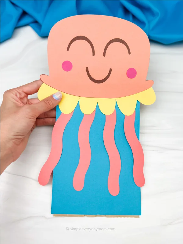 hand holding paper bag jellyfish craft