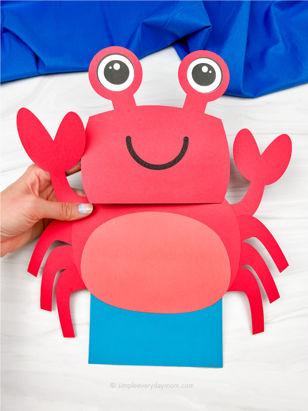 hand holding paper bag crab craft