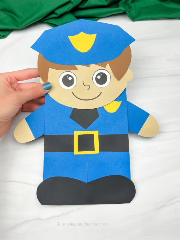 hand holding police officer puppet craft