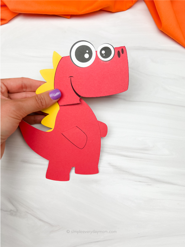 hand holding dinosaur Father's Day card craft