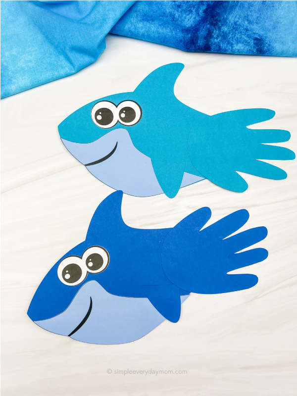 light blue and dark blue shark handprint crafts