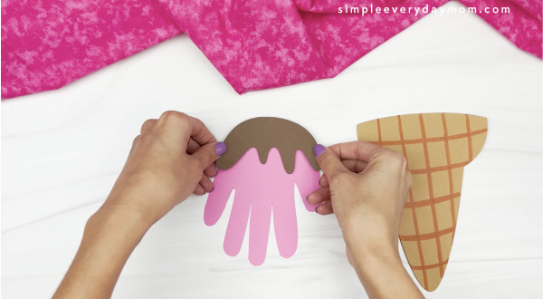 hand gluing chocolate drizzle to top of handprint ice cream craft