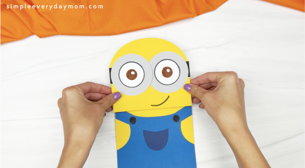 hand gluing head to minion puppet