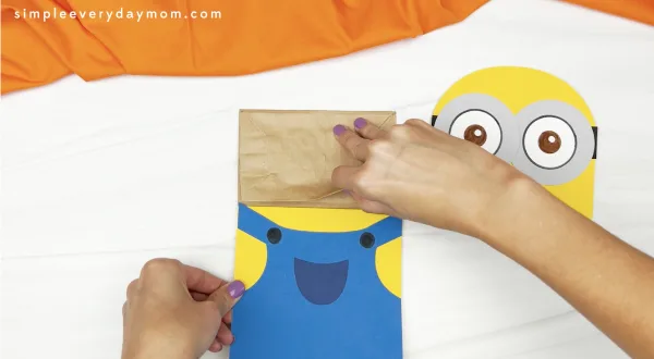 hand gluing body to minion puppet