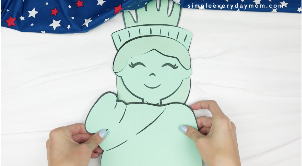 hand gluing dress to handprint Statue of Liberty craft
