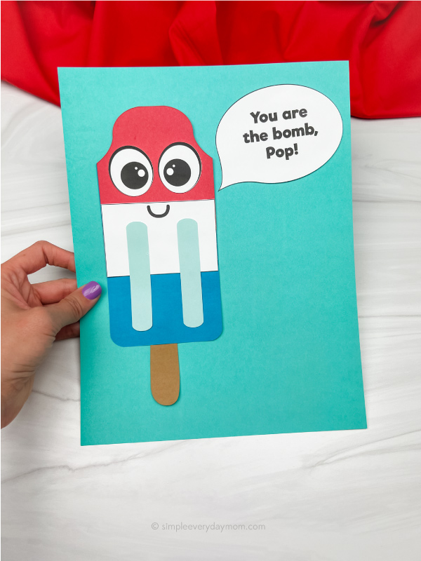 hand holding popsicle stick Father's Day craft