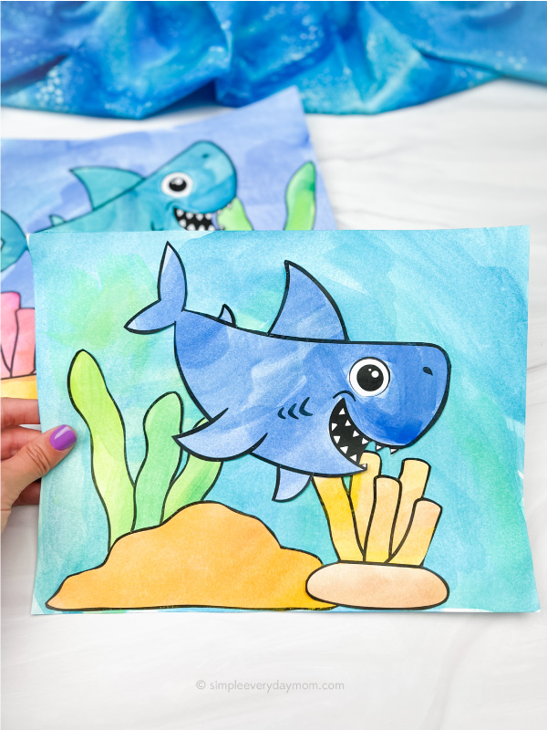 hand holding watercolor shark art