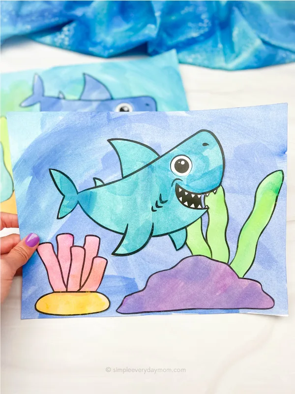 hand holding watercolor shark art