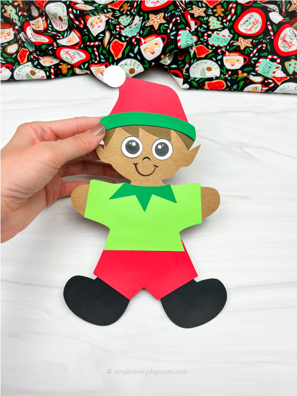 hand holding elf gingerbread in disguise craft