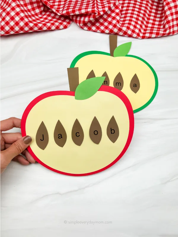 hand holding apple name craft with another one in the background