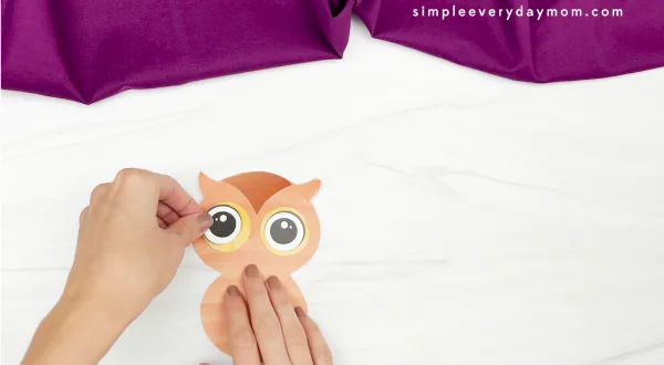 hand gluing eye to watercolor owl