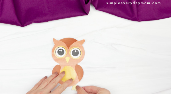 hand gluing feet to watercolor owl