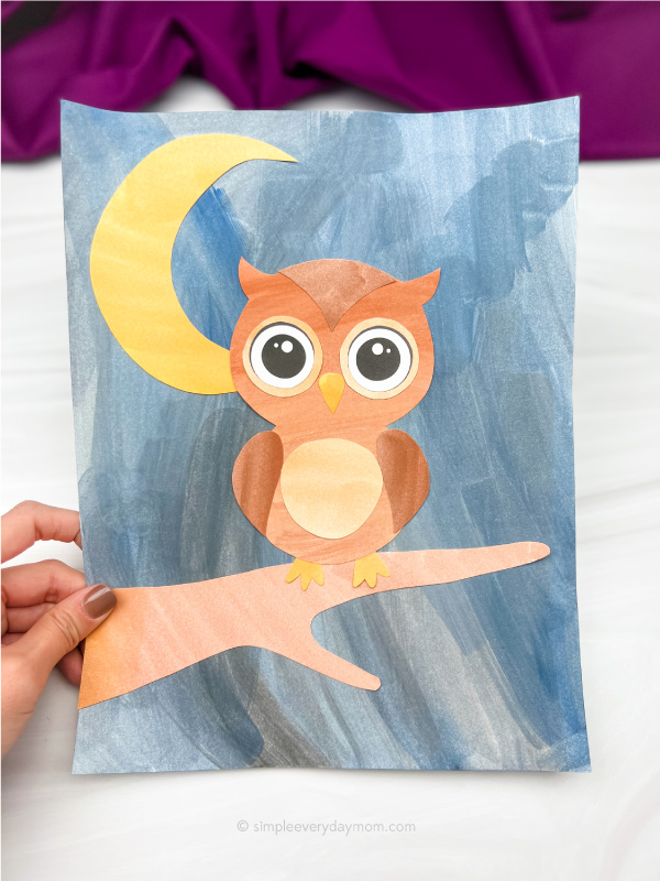 hand holding owl art for kids
