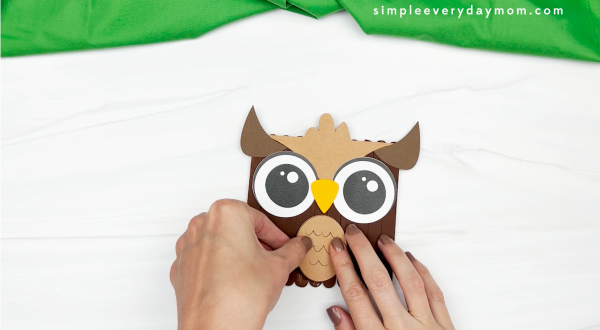 hands gluing belly to owl popsicle stick craft