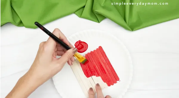 hand painting popsicle sticks red