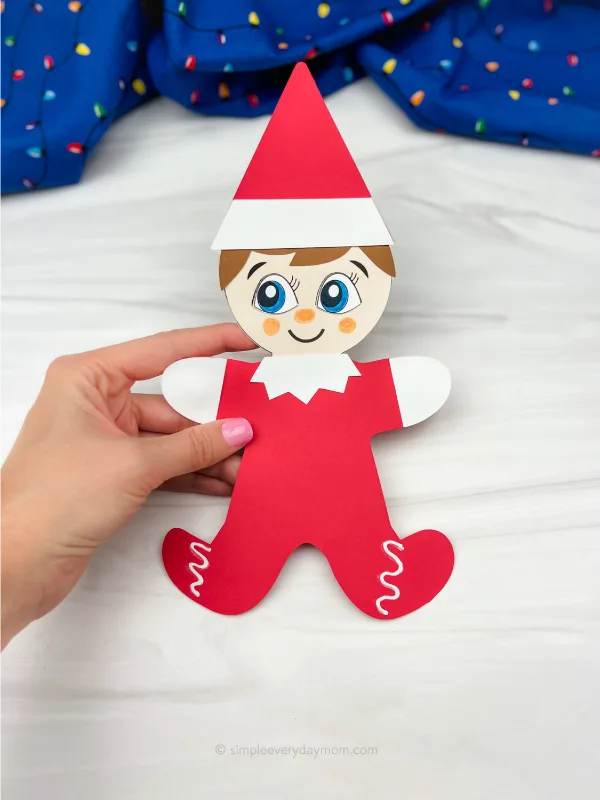 hand holding elf on the shelf gingerbread man disguise craft