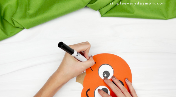 hand drawing eyebrows to pumpkin emotion craft