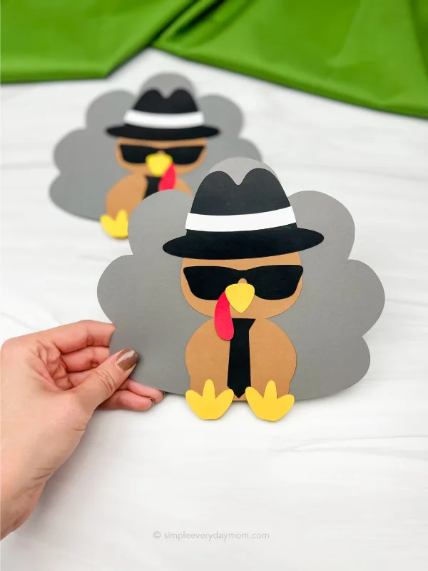 hand holding spy turkey craft with another one in the background