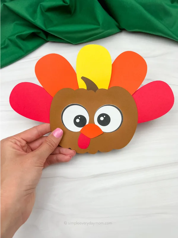 hand holding turkey pumpkin craft